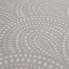 Close up of shiitake tan colored linen background with white dotted fan design on a low profile washable floor mat