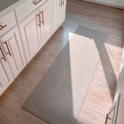 Overhead view of Un-Rug Shiitake low-profile runner mat in a kitchen.