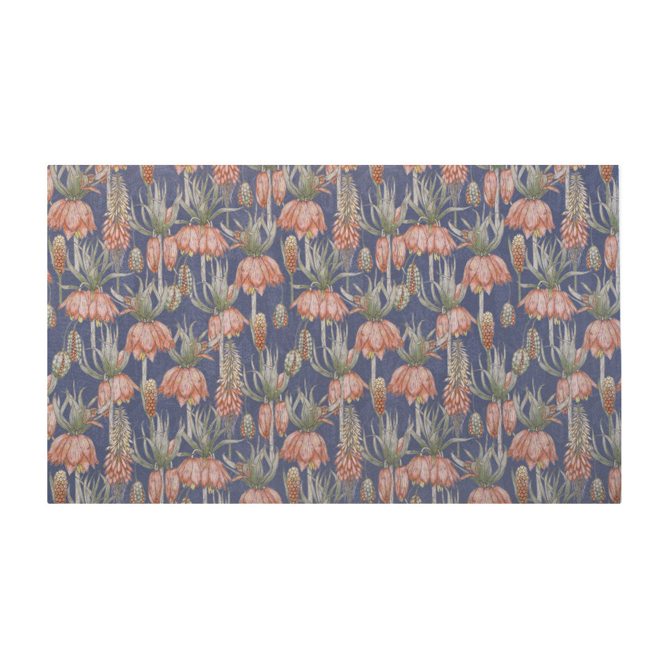 Overhead shot of Dark floral print with pink flowers on blue grey background on a low profile washable floor mat size medium