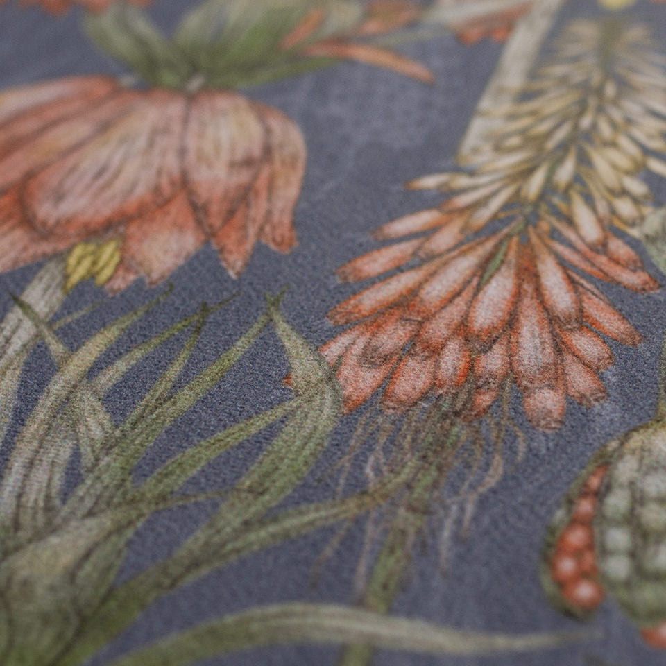 Close up of a dark floral print with pink flowers on blue grey background on a low profile washable floor mat