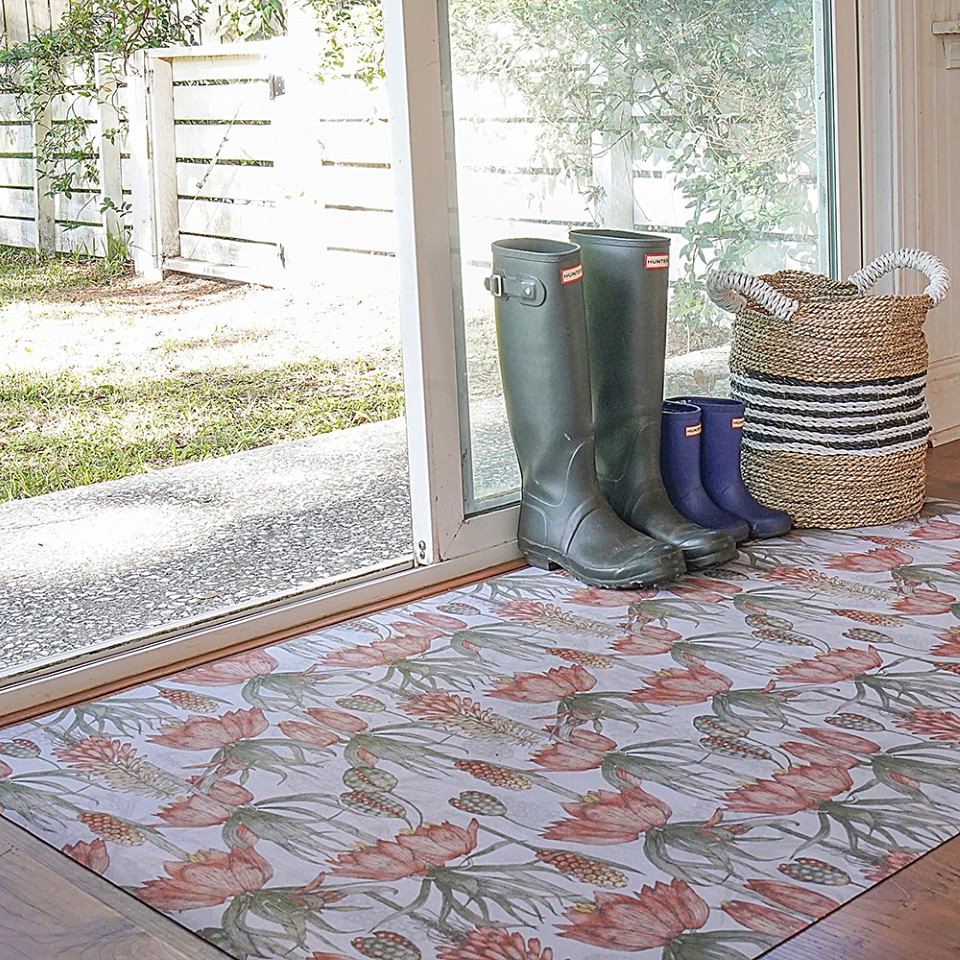 Light floral print with pink flowers on light grey greige background on a low profile washable floor mat