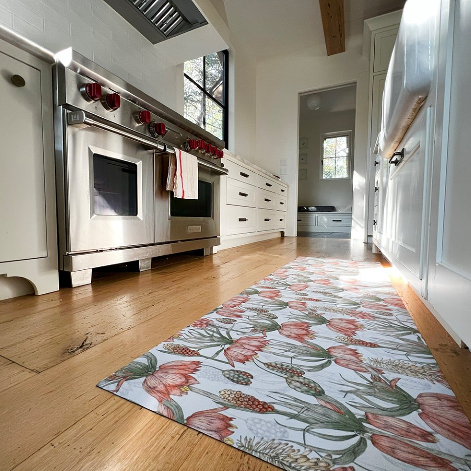 Light floral print with pink flowers on light grey greige background on a low profile washable floor mat