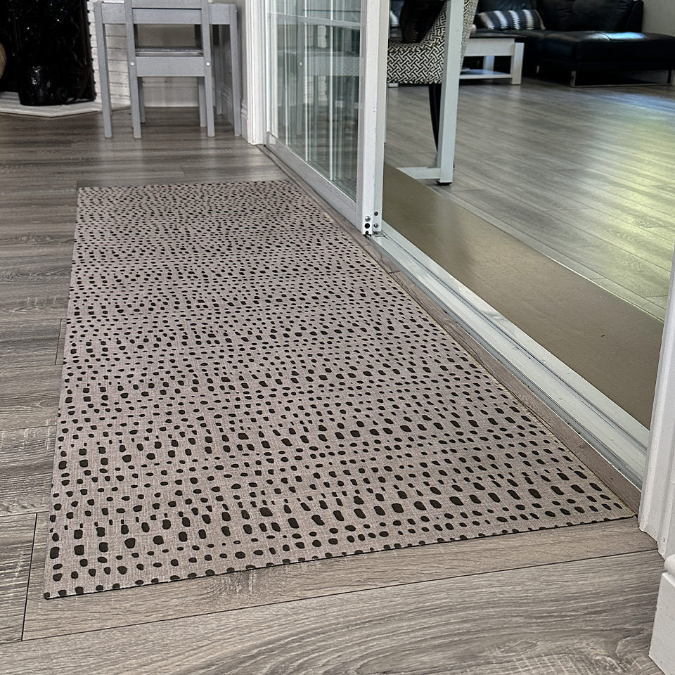 Low-profile Indigenous Dots runner mat in front of a sliding door to an enclosed deck space