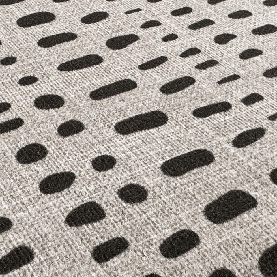 Detailed image of Indigenous Dot's surface of a printed textured cream color with organic shaped dots of dark brownish-grey.