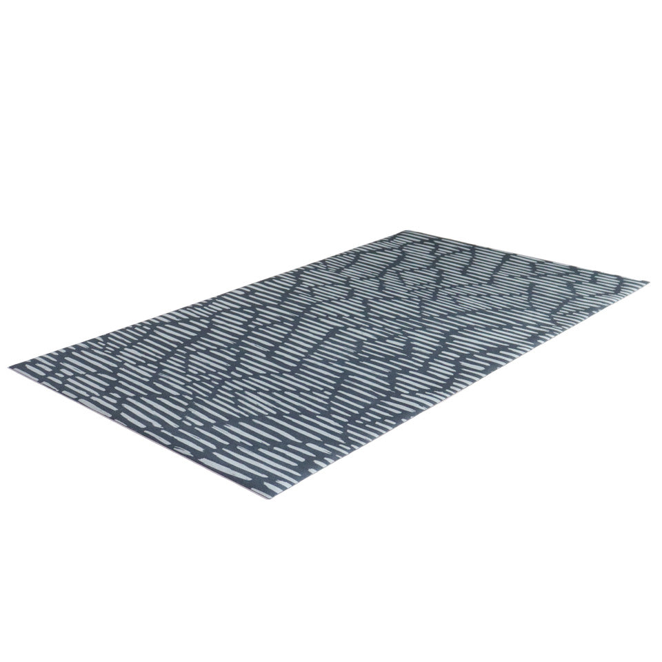 Overhead angled shot of Sea salt organic line abstract design on dark storm cloud blue background printed on a thin low profile machine washable floor mat for indoor use.