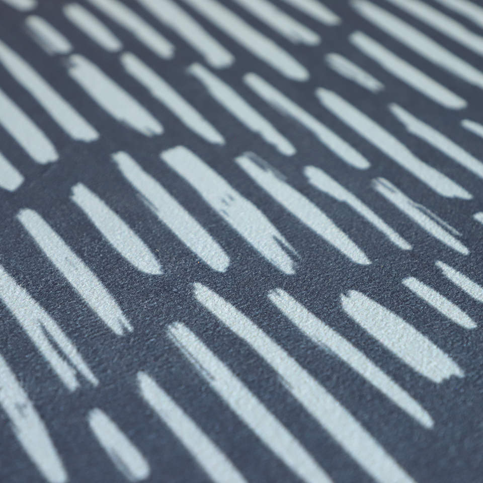 Close up of Sea salt organic line abstract design on dark storm cloud blue background printed on a thin low profile machine washable floor mat for indoor use.