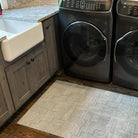 Small Un-Rug Organic Squares in a laundry room covering the floor in front of both the washer, dryer, and sink