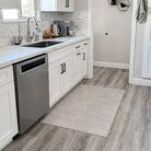 Un-Rug kitchen mat with soft knitted surface, rubber backing, and machine washable, perfect for the kitchen.