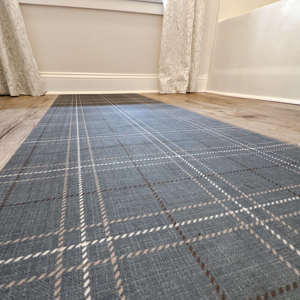 Storm Cloud blue printed linen texture with shiitake tan and urbane bronze plaid stripes on a low profile washable indoor floor mat