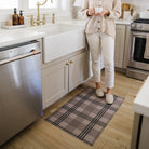 Incredibly stylish, indoor Un-Rug kitchen mat in front of a sink for its low-profile and single-piece washable construction.