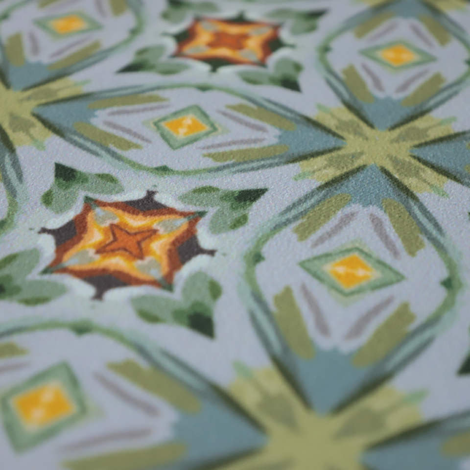 Close up of oranges, yellows, blues and greens.  Neutral kaleidoscope pattern in aquas, apple green, and hints of orange on this low profile washable interior floor mat. 