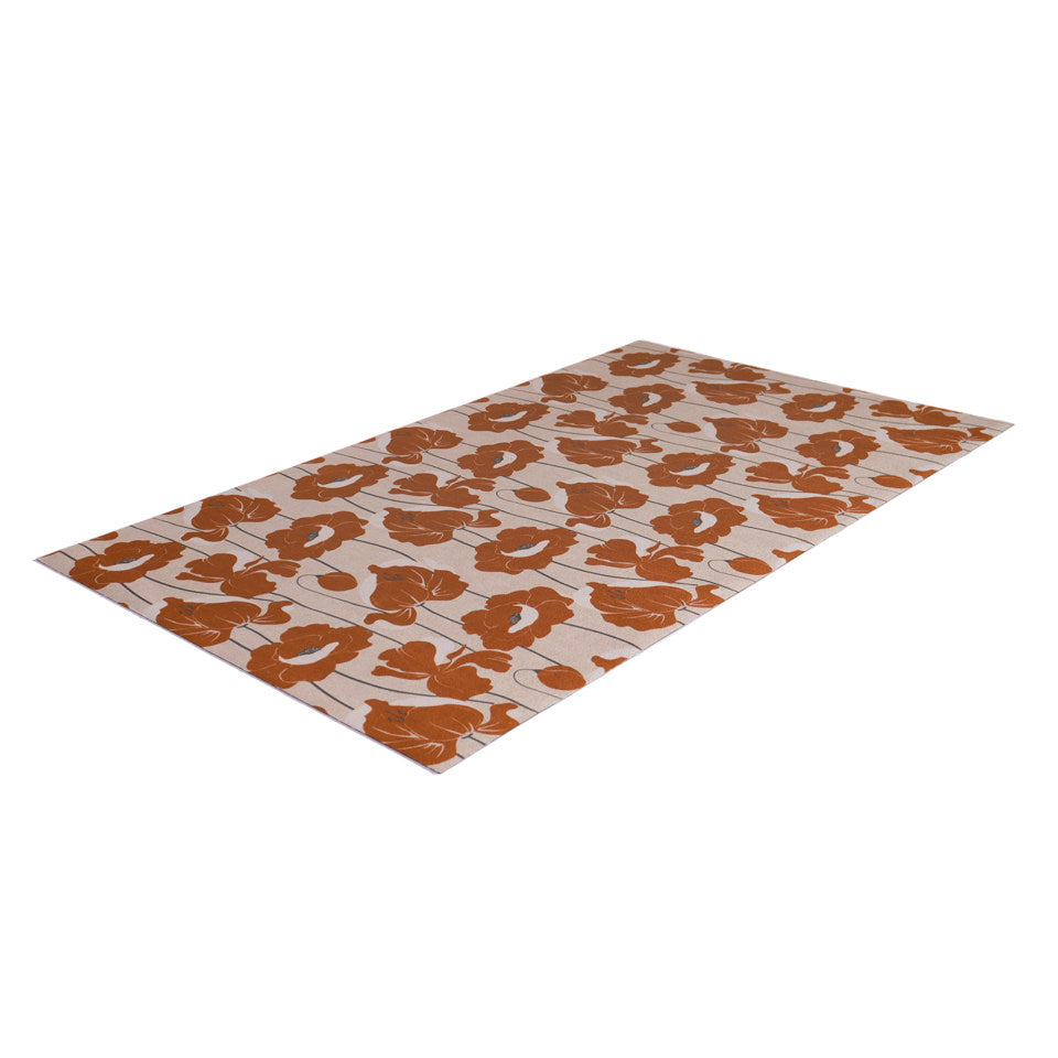angled image of light beige mat covered in orange poppies