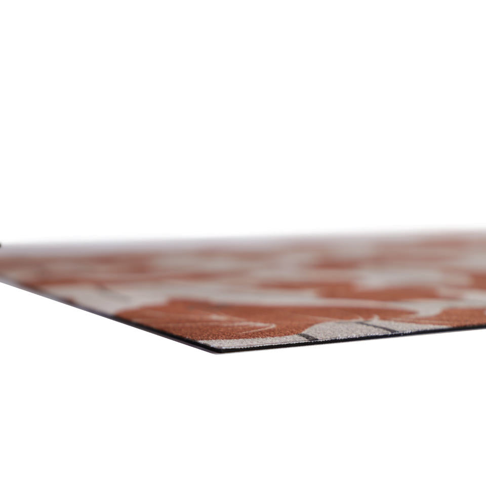 close up of corner of extremely low-profile mat with durable rubber backing and soft fabric surface. 