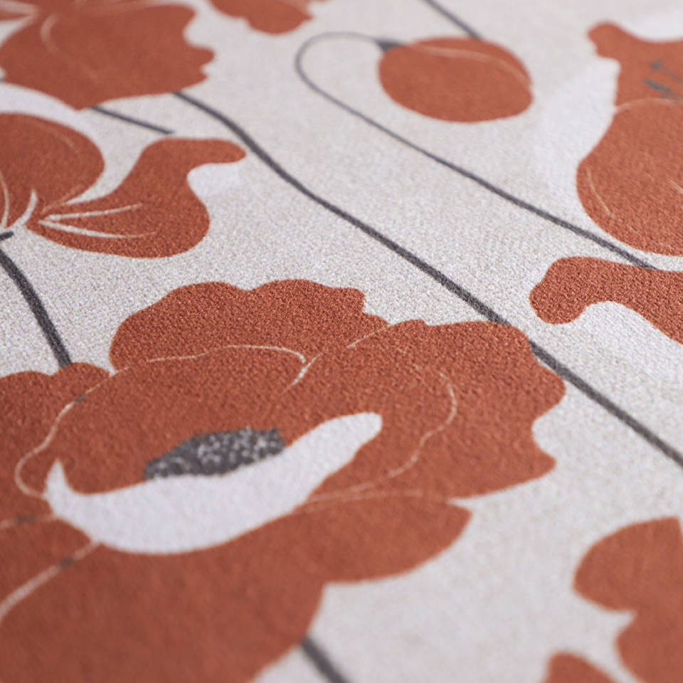 Close up if soft light beige mat with floral pattern in deep orange (earthen jug)
