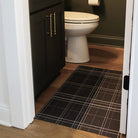 The Sydney Plaid classic design on a dark background located in a small half bath