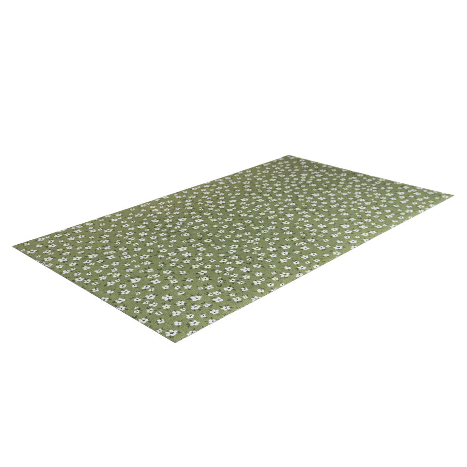 angled thin earthy green mat with small white flowers