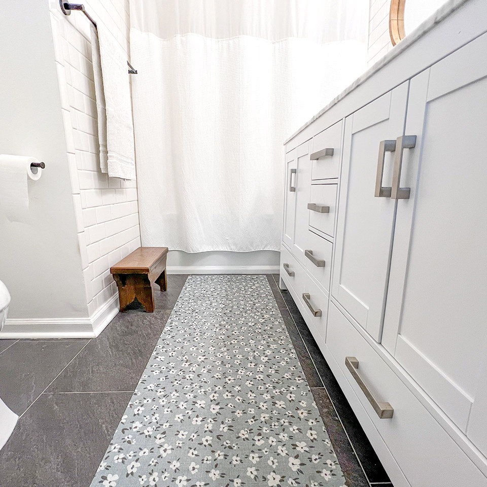 The Un-Rug low-profile decorative floor mat also serves as an excellent bathroom mat placed in front of a double vanity.