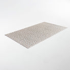 extremely low profile mat in color shiitake (light neutral tone) with small white flowers