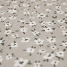 close up of soft fabric with neutral/beige (shiitake) background and small white flowers