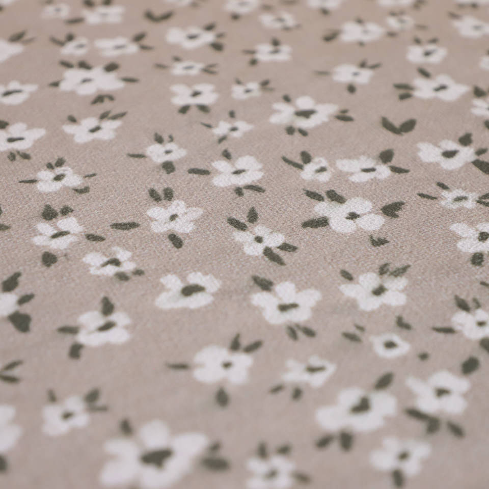 close up of soft fabric with neutral/beige (shiitake) background and small white flowers