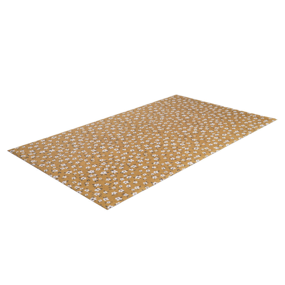angled image of incredible unrug floor covering in tiny flowers tassel (yellow)