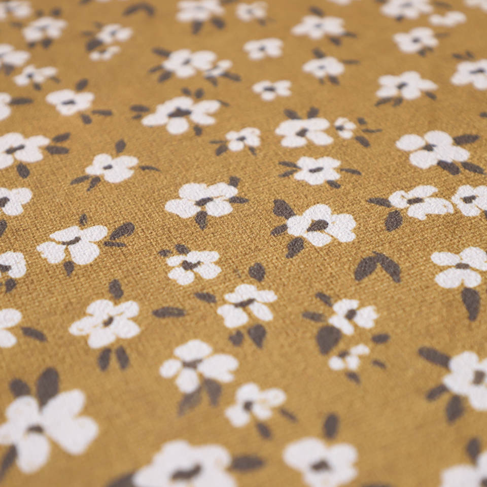 close up of tiny flowers design with yellow (tassel) back ground and white floral pattern