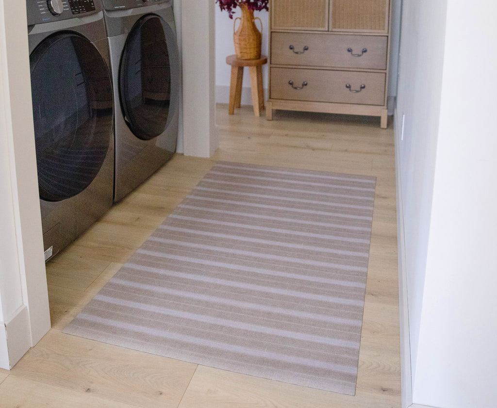 Ultra low-profile UnRug mat providing floor protection in laundry room.