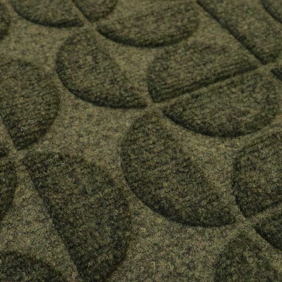 Detailed shot of Hourglass' bi-level surface and semi-oval alternating pattern in olive; all-weather outdoor mat