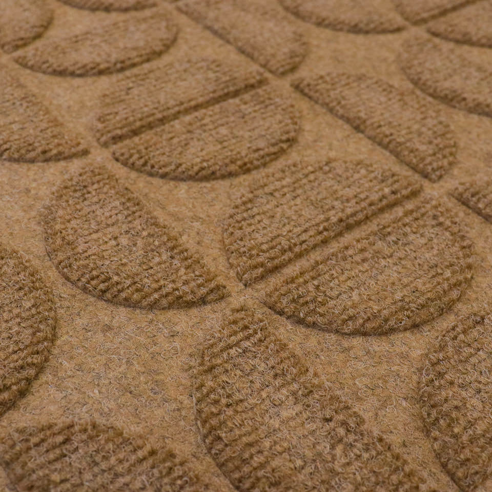 Detailed shot of Hourglass' bi-level surface and semi-oval alternating pattern in wheat; all-weather outdoor mat