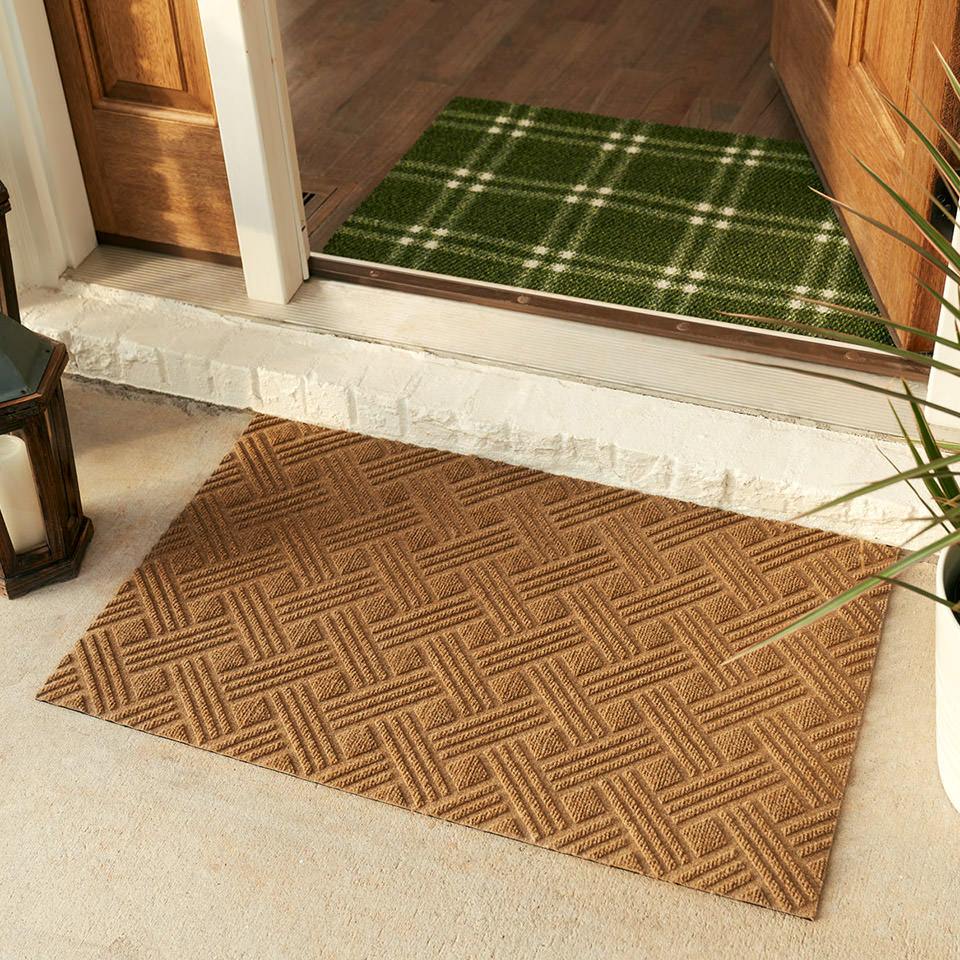 WaterHog Luxe classic thatch doormat in wheat placed outside front door paired with green and white classic plaid doormat placed inside entryway