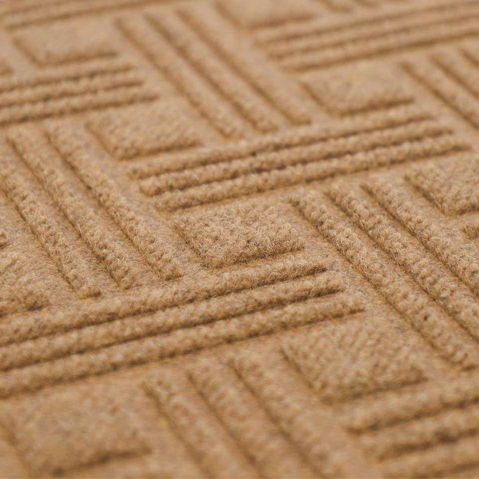 Close up of WaterHog Luxe classic thatch geometric pattern in wheat (sandy beige)