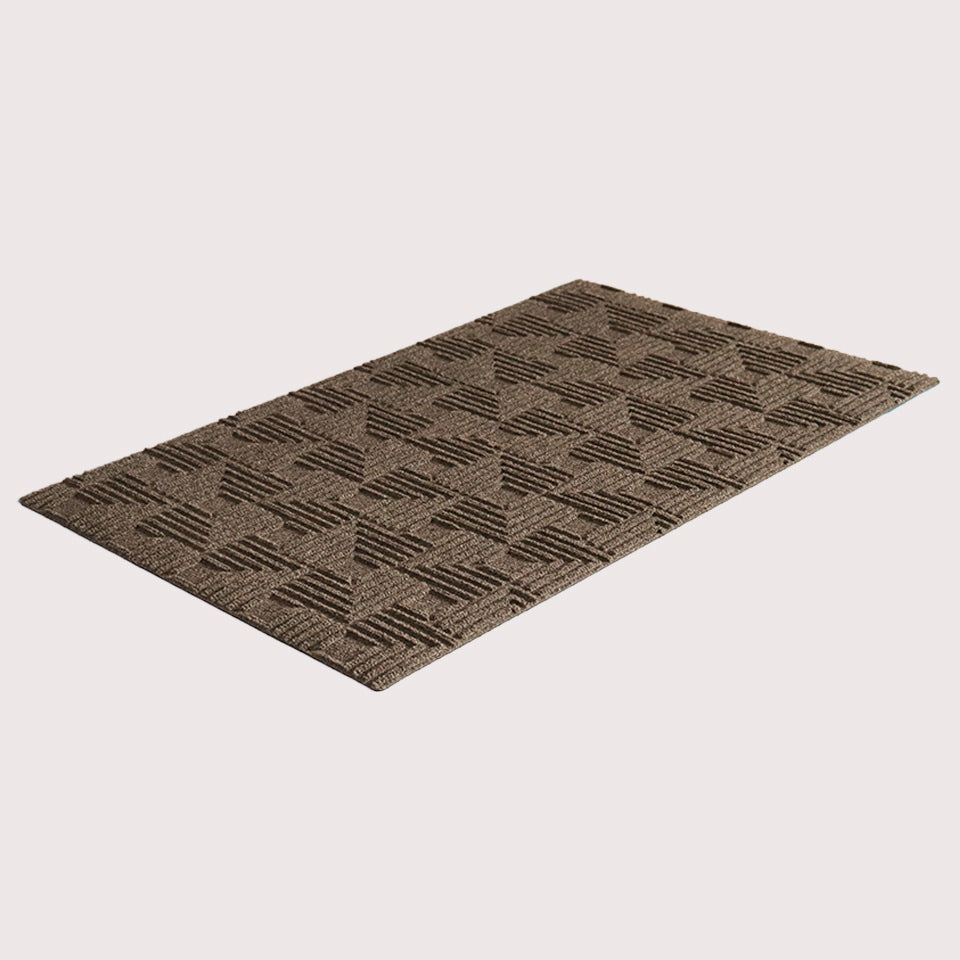 Angled image of the single-door Labyrinth mat in the color greige on a creamy white background.
