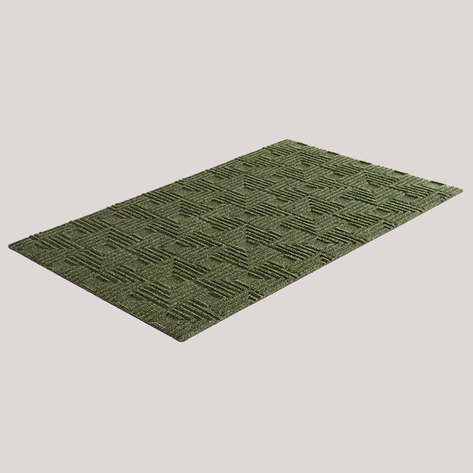 Angled image of the single-door Labyrinth mat in the color olive on a creamy white background.