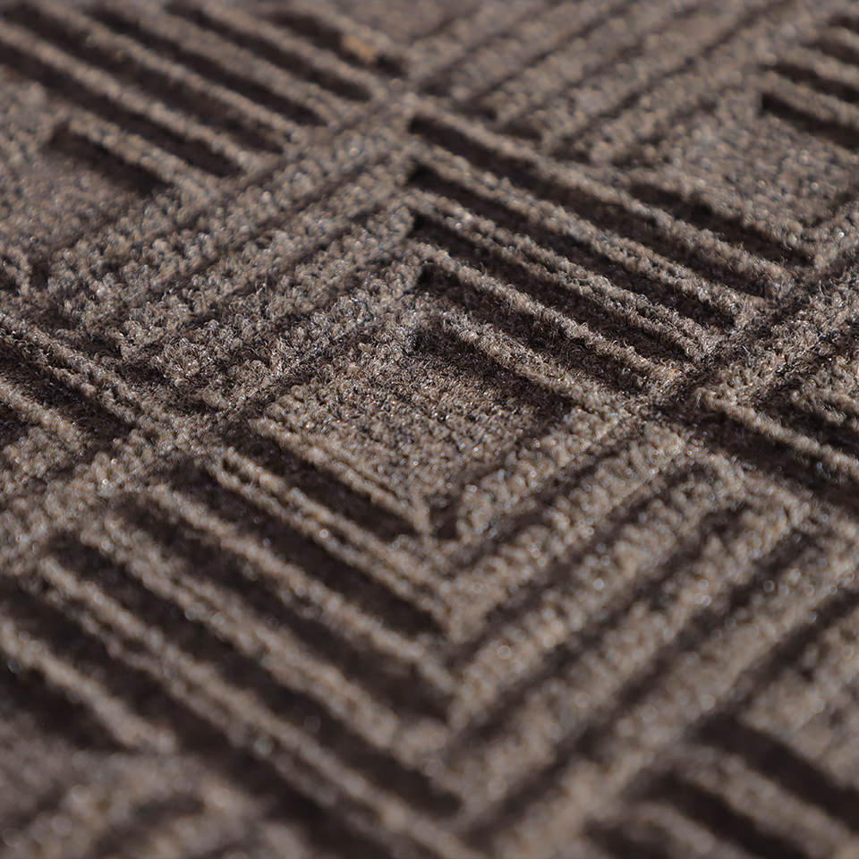 Up close, detailed image of Labyrinth’s surface, capturing the complex linear design carved out by the bi-level surface, shown in greige.