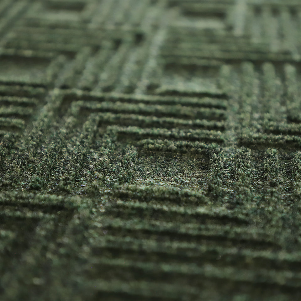 Up close, detailed image of Labyrinth’s surface, capturing the complex linear design carved out by the bi-level surface, shown in olive.
