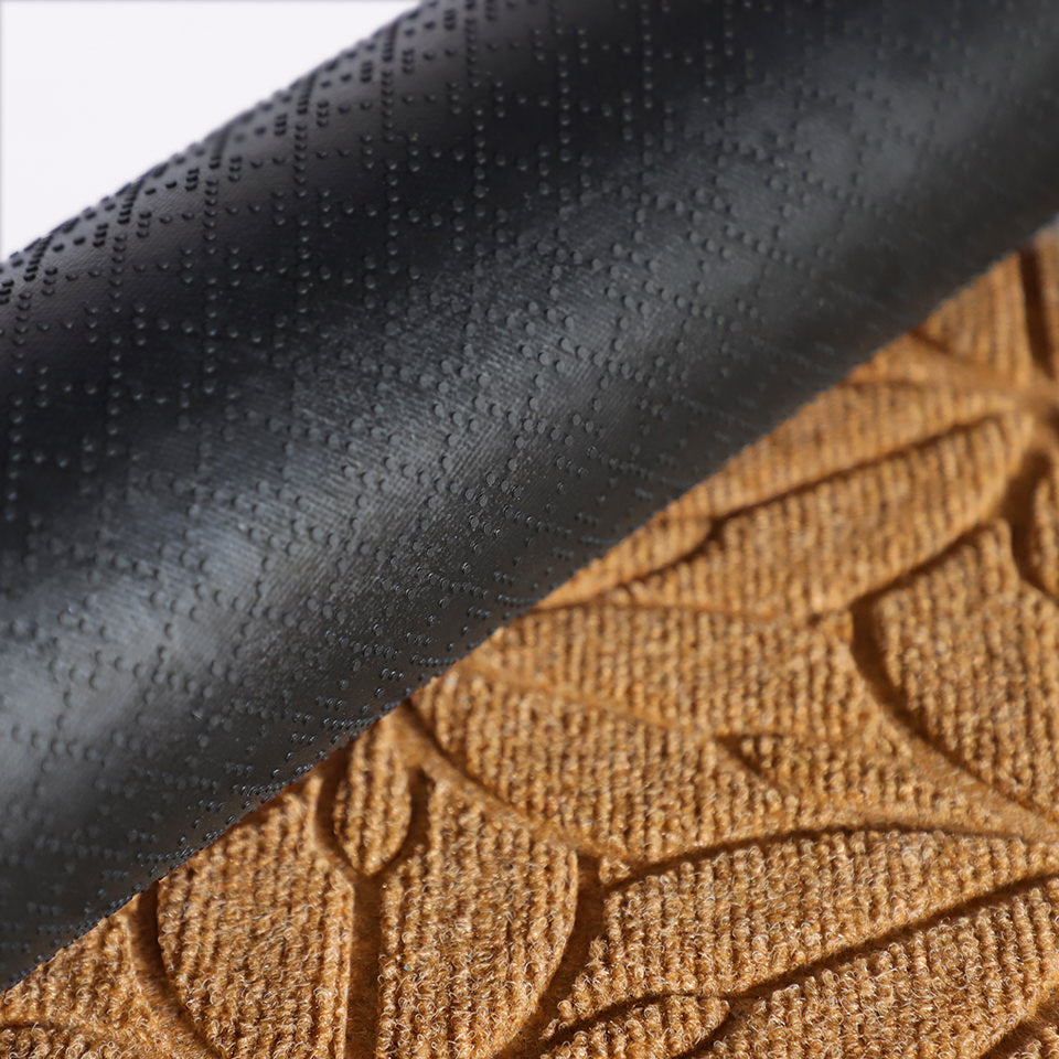 A close-up image of the all-weather Magnolia mat half rolled showing both the rubber backing and wheat surface.