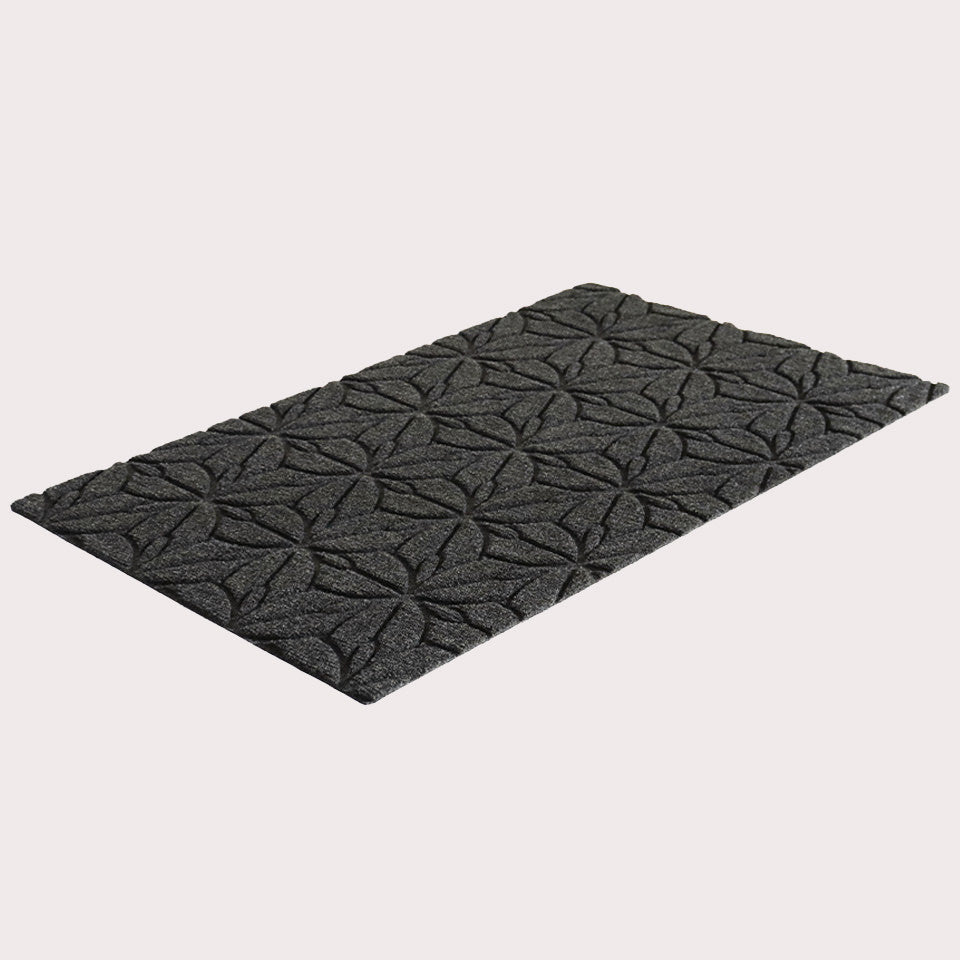 Angled image of the single-door Magnolia mat in the color graphite on a creamy white background. 