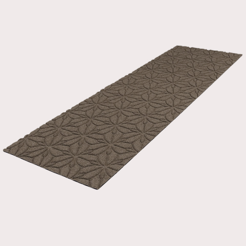 Angled image of the double-door Magnolia mat in the color greige on a creamy white background. 