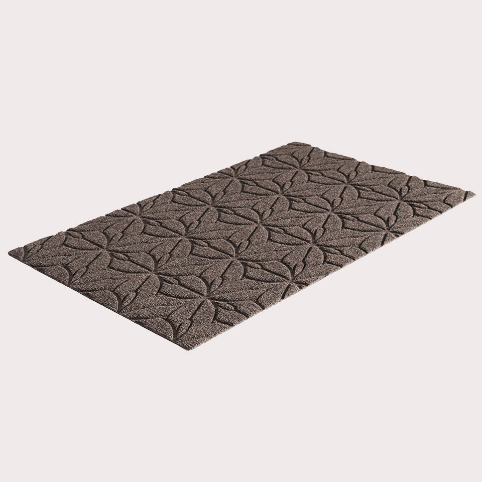 Angled image of the single-door Magnolia mat in the color greige on a creamy white background. 