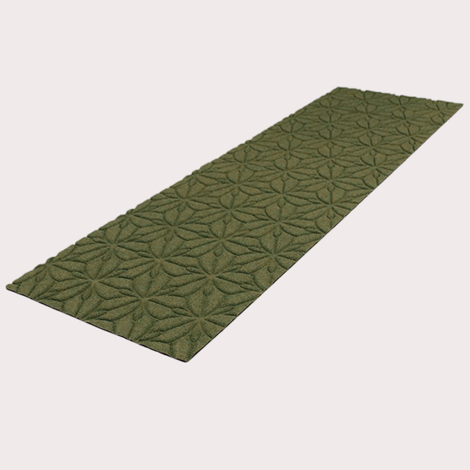 Angled image of the double-door Magnolia mat in the color olive on a creamy white background. 