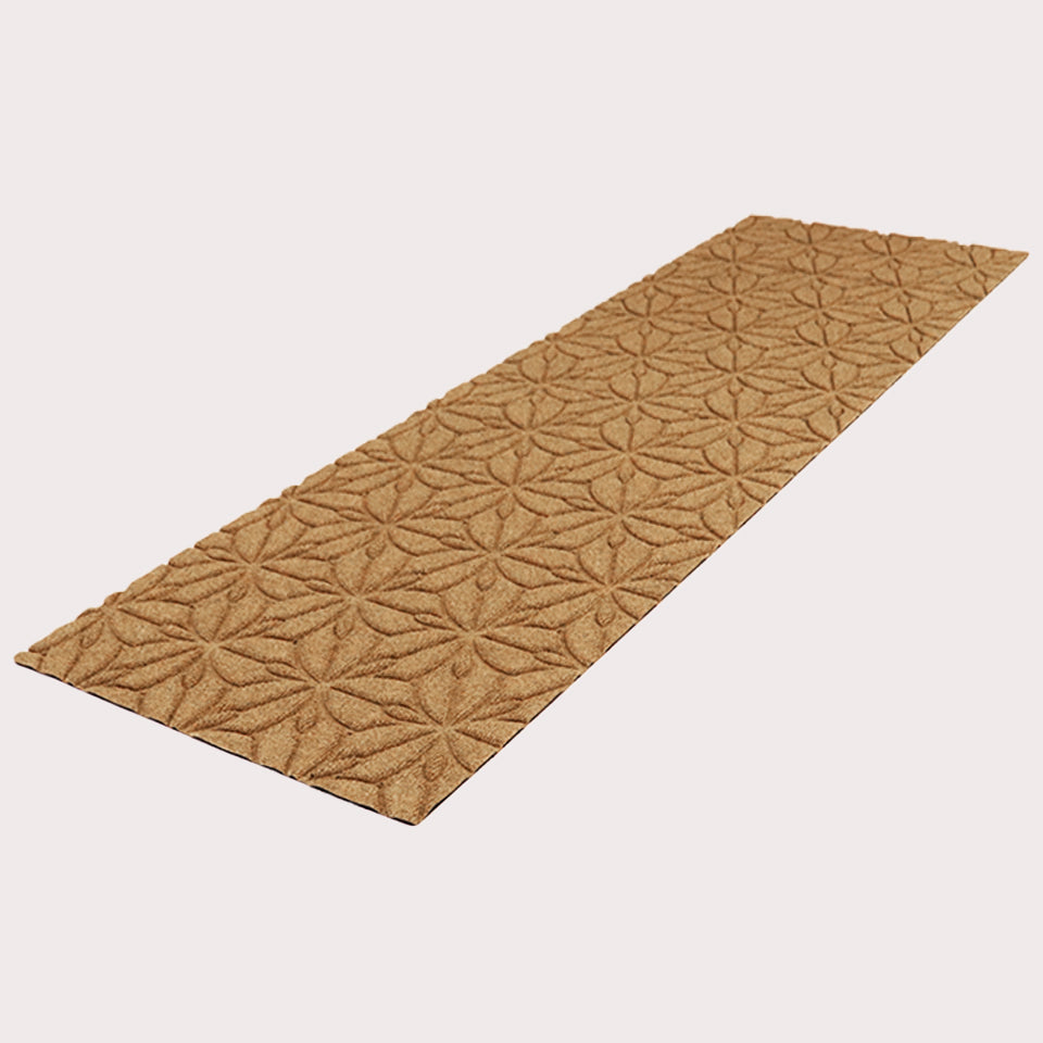 Angled image of the double-door Magnolia mat in the color wheat on a creamy white background. 