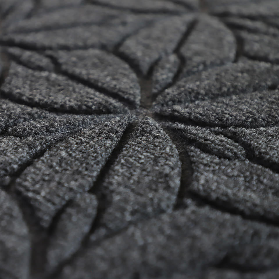 Up close, detailed image of Magnolia’s surface, capturing the floral design carved out by the bi-level surface,, shown in graphite.