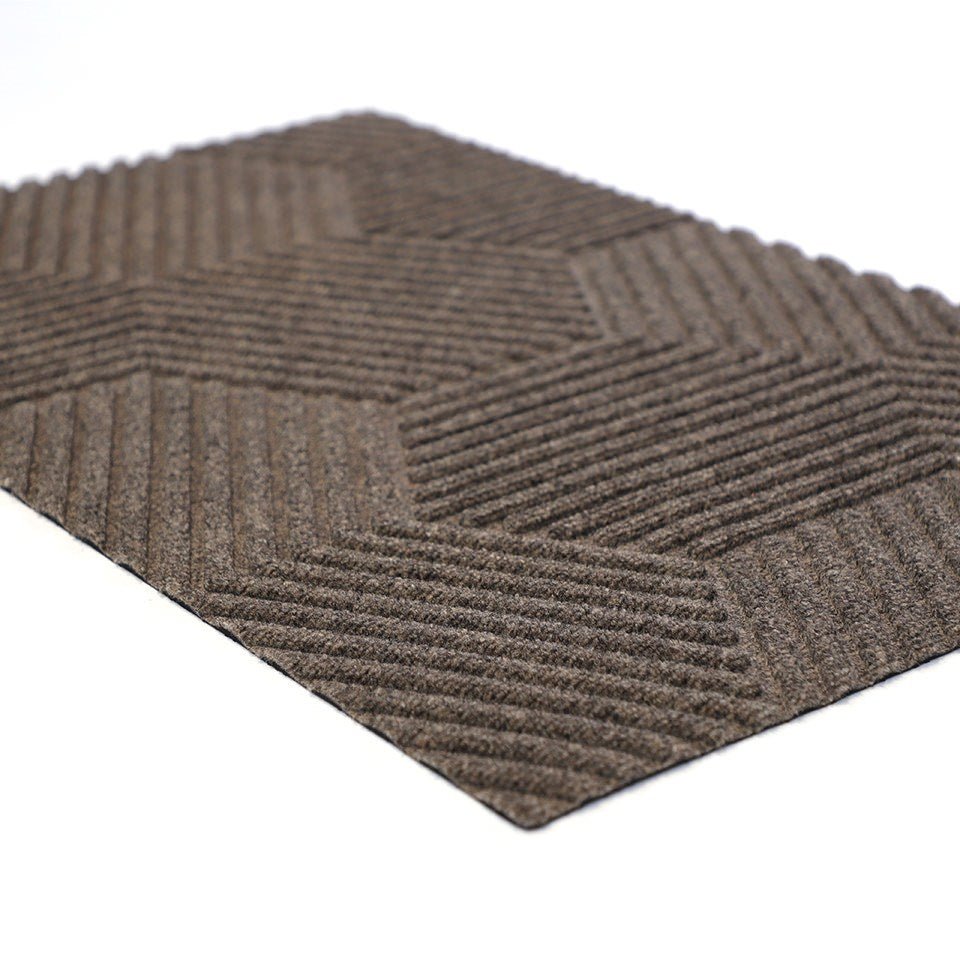 Angle shot of greige Zephyr geometric doormat.  The best low profile doormat on the market.