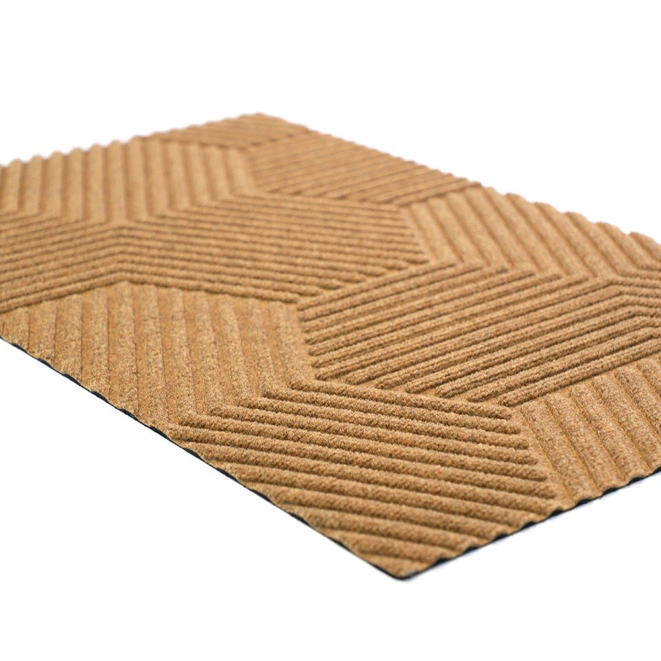 Angle shot of zephyr geometric doormat in wheat color.  Part of our all weather fade resistant doormat collection.