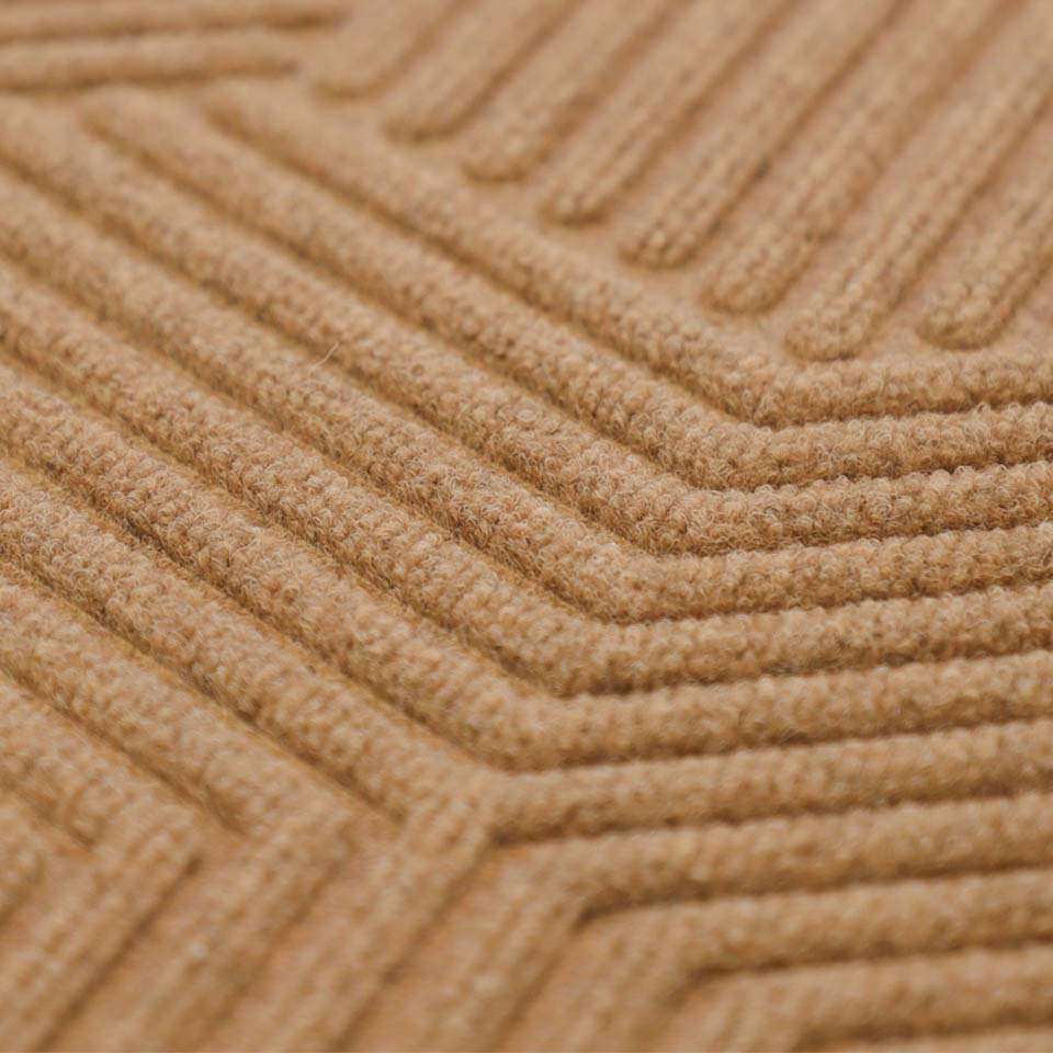 Close up of zephyr doormat in wheat color.  Beautiful geometric patterned doormat design.