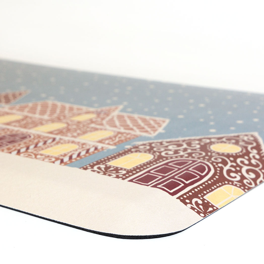 Corner view Gingerbread House Christmas anti-fatigue kitchen mat with wipeable surface and winter holiday design for kitchen comfort.