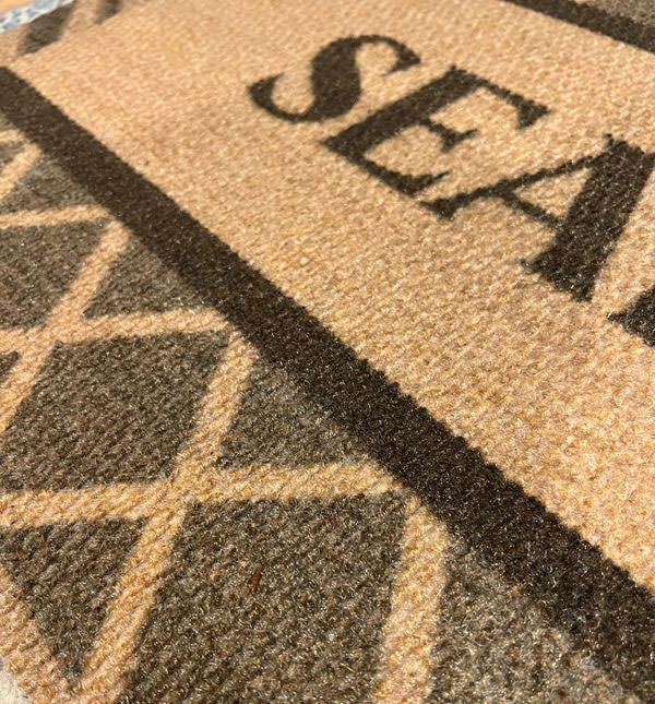 Close up of stain resistant argyle personalized doormat customized with last name