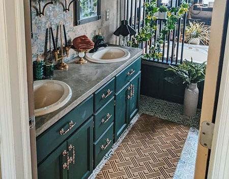 Moody bathroom makeover with painted tile floors and painted oak cabinets