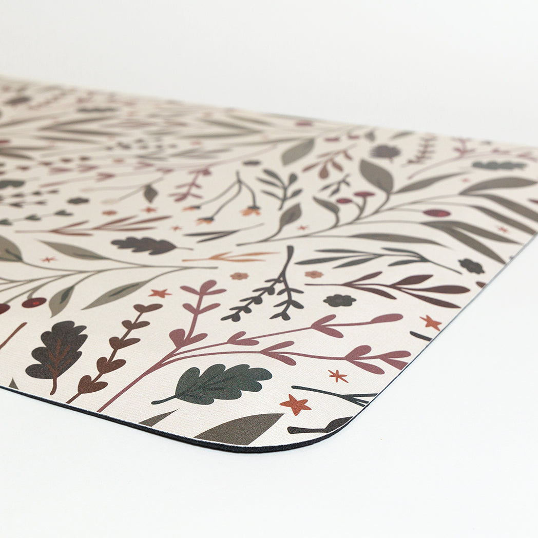 Corner view Sprig & Berry foliage Christmas anti-fatigue kitchen mat with wipeable surface and winter holiday design for kitchen comfort.