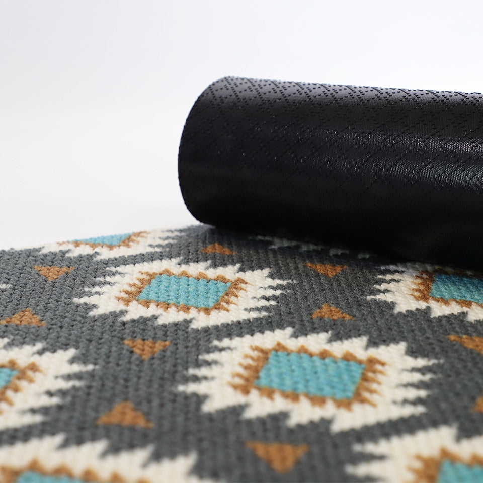 Aztec mat with corner rolled in to show rubber cleated backing